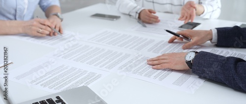 Fotografie Business partners discussing contract terms, reviewing legal documents during an