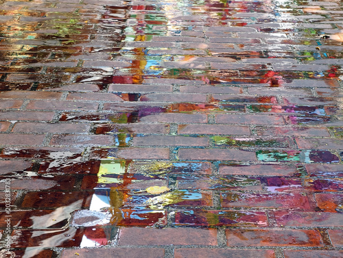 wet asphalt road with puddle in the city