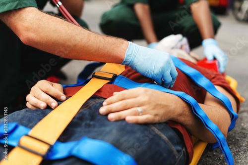 Photos Emergency responders assist an injured person on a stretcher