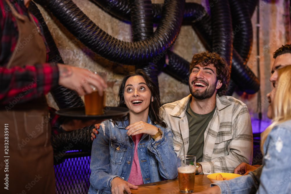 Fototapeta premium Diverse friends drinking beer in industrial style pub