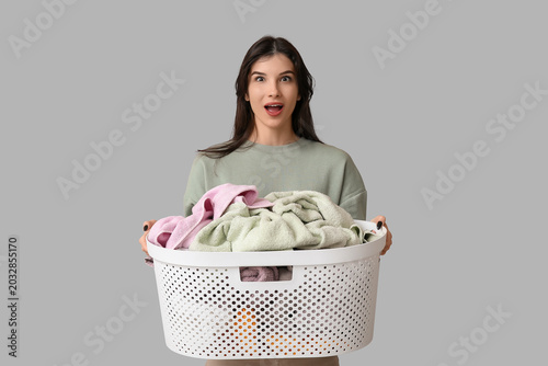Shocked young woman holding...