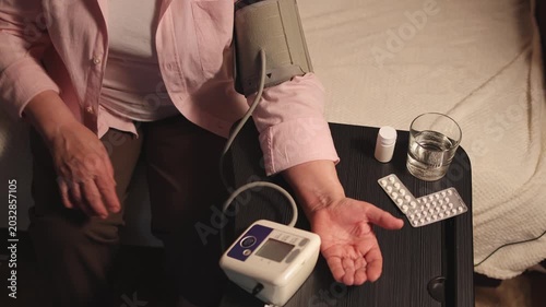 Elderly woman. Blood pressure monitor. Measure blood pressure. Slow motion video. High quality 4k footage