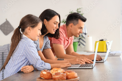 Happy family with laptops r...