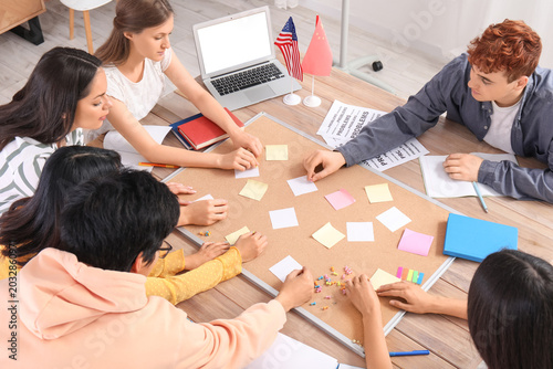 Young students studying at ...