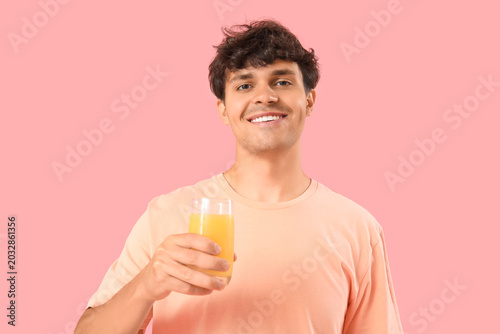 Young man with glass of ora...