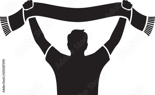 Fotografija A black silhouette of a person, likely a sports fan, seen from behind, holding a scarf aloft with both hands
