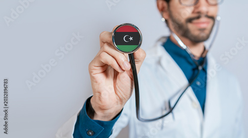 Photos Doctor holding stethoscope with Libya flag