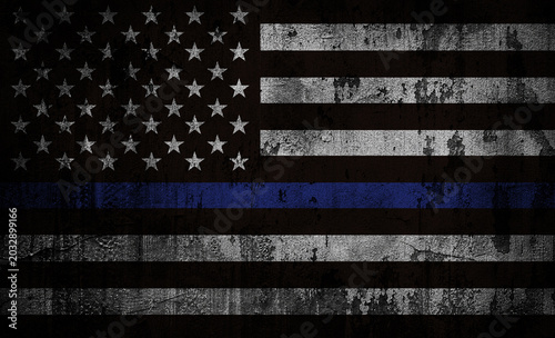 Thin Blue Line US flag on a rough cracked wall texture, symbolizing support and solidarity for law enforcement officers.