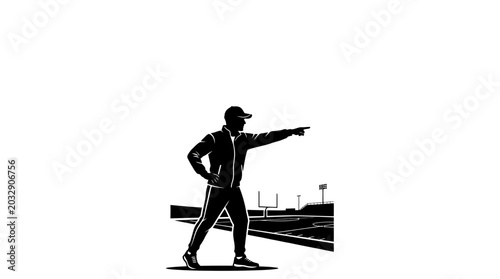 Foto A silhouette of a football coach pointing forward on the field.