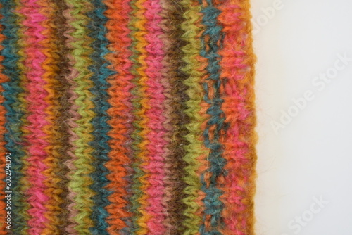 pice of hand knitting on knitting needles colourful stripes 