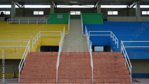 Fotografie Colorful empty stadium bleachers with stairways