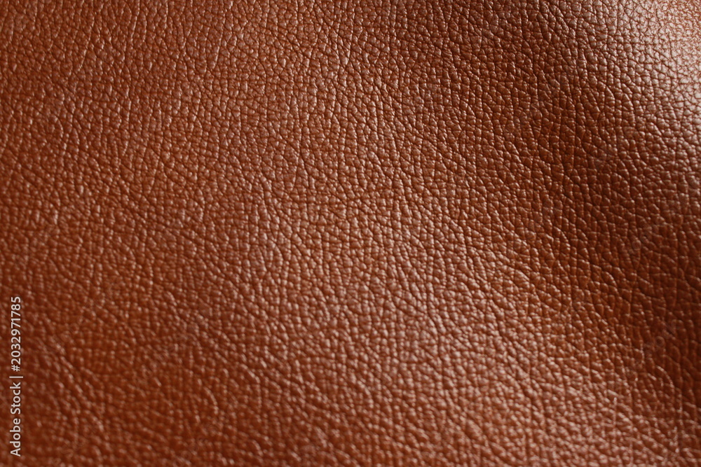 Fototapeta premium Reddish brown grained leather texture close-up