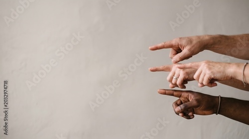 Diverse hands pointing in the same direction, emphasizing unity and focus.