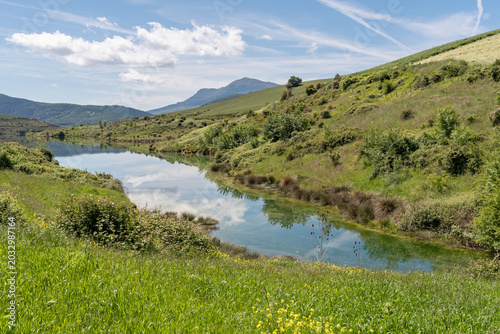 Tableau sur toile Small reservoir between scrubland and cultivated fields