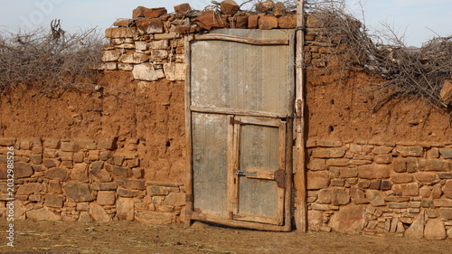 Obraz na płótnie Rustic corrugated metal gate in traditional Moroccan farm wall
