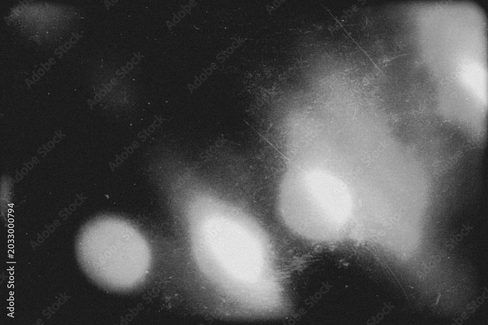 Fototapeta premium retro film overlay effect with scratch dust and light leaks, retro grain noisy film distressed texture light leak flare on black background,black and white abstract light background