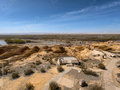 Stunning landscape of Wucaitan (Five Colored Hills) and the Irtysh River in Burqin, Xinjiang, China.