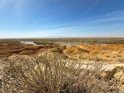 Stunning landscape of Wucaitan (Five Colored Hills) and the Irtysh River in Burqin, Xinjiang, China.
