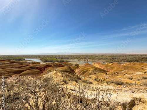 Stunning landscape of Wucaitan (Five Colored Hills) and the Irtysh River in Burqin, Xinjiang, China.