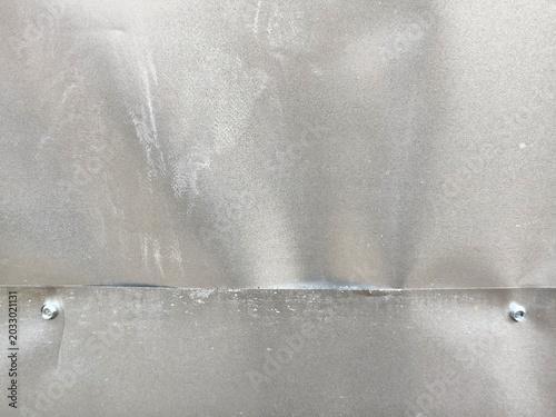 Slika na platnu ​Industrial galvanized steel sheets overlap joint with hex screws, dented zinc metal plate background with scratches