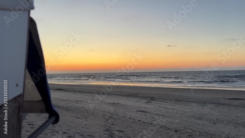 North sea beach at dusk background with hooded beach chair and copy space