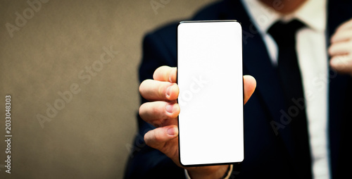 Fotografi Man hand holding blank empty white screen smart phone.