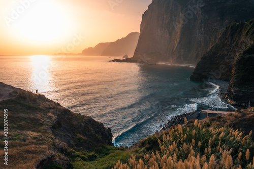 Photos Panoramic view of massive ocean cliffs and coastline in golden sunrise light