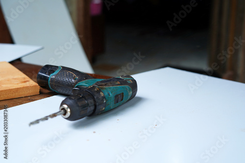 Wireless Drill machine on white board. image