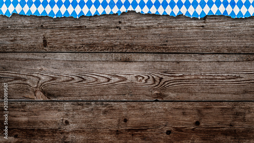 Fotografía Wooden background with blue and white checkered pattern commonly seen at festiva