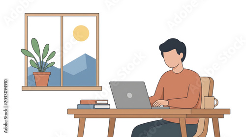 Young man working on a laptop at his desk in a home office