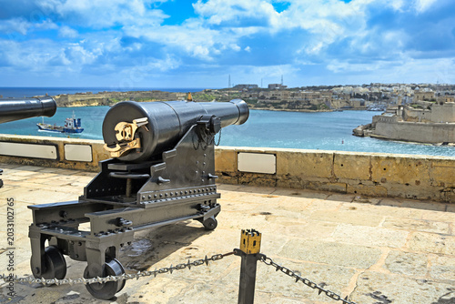 Saluting Battery Cannon and Fort Saint Angelo in Valletta Malta