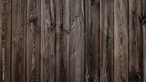 Foto Wooden wall texture showing brown vertical panels arranged in a pattern creating