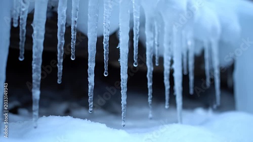 Close up of icicles hanging with water drops winter concept