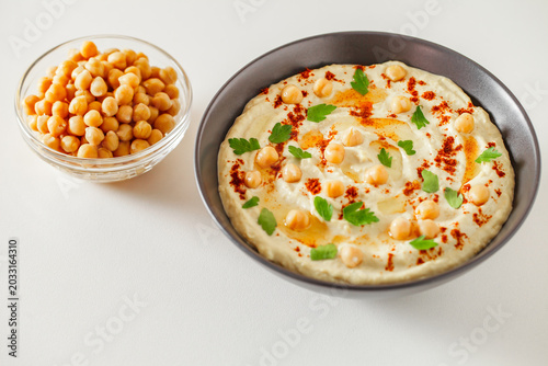 hummus in a bowl with chickpeas and olive oil, selective focus