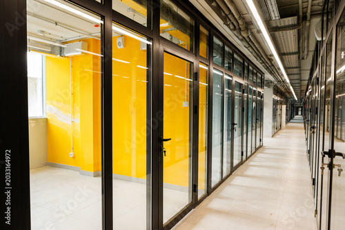 Bright office corridor with yellow accent wall