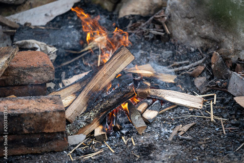 Cozy outdoor cooking atmosphere featuring fire flames