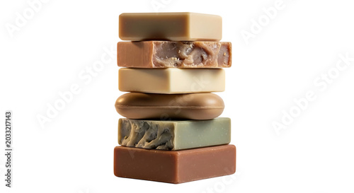 stack of handmade soaps in varying earth tones against a black background