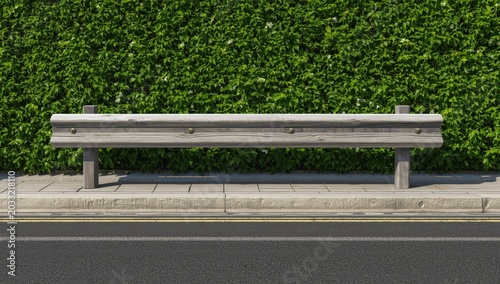 Timber barrier on a cement walkway. Tall hedge behind and dual carriageway ahead. Space available for text.