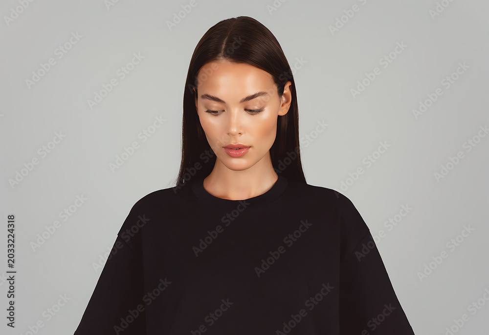 Fototapeta premium Young Woman Looking Down in Plain Oversized Black T Shirt for Minimal Studio Fashion Mockup