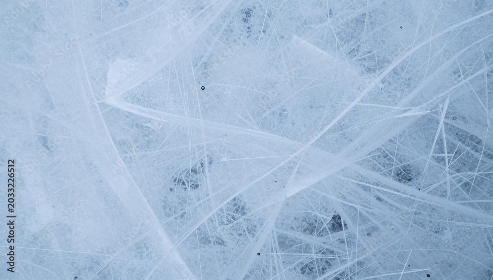Fototapeta premium Frozen lake surface displaying intricate ice patterns and cracks forming a beautiful abstract design