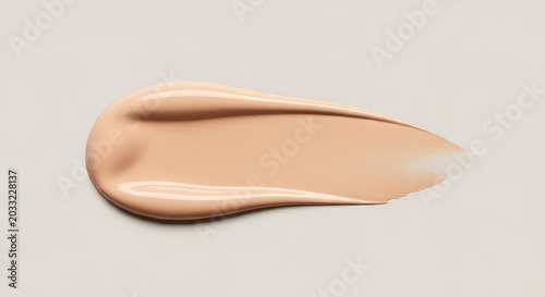 A smooth swatch of beige liquid foundation showing a silky creamy texture. This nude colored cosmetic sample is a perfect makeup smear, swatch, skin, cover