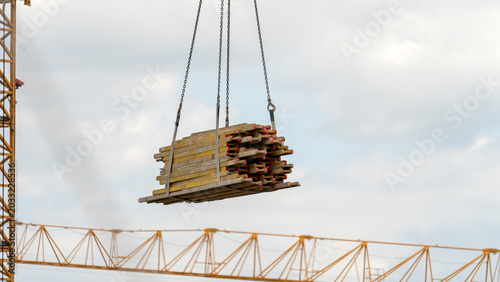Fotografie Heavy timber beams hang suspended mid-air