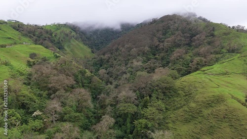 Wide drone pan shot of green mountain valley and cloud forest in Coronado, Costa Rica