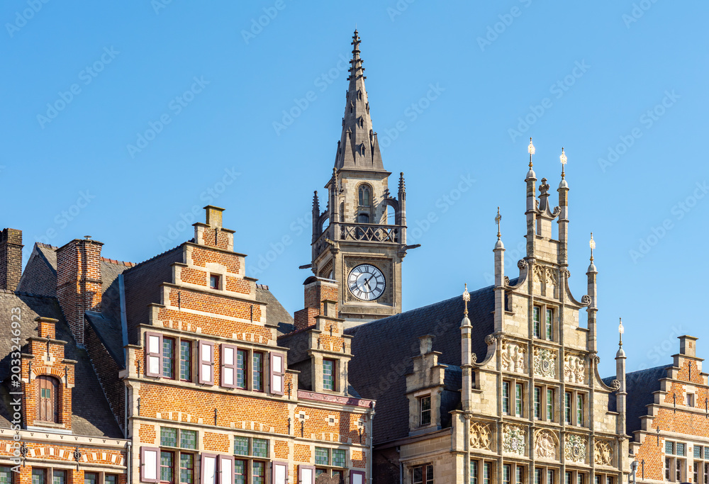 Obraz premium Medieval architecture of Graslei quay at Lys (Leie) river with Clock tower of former Post Office, Ghent, Belgium