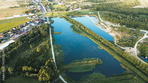 Slika na platnu Drone perspective of industrial warehouse and adjacent water reservoir