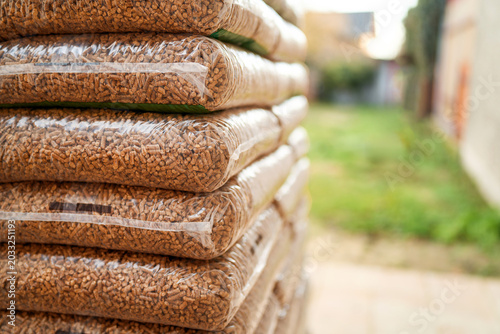 Photos Renewable biomass fuel in plastic bags on pallet