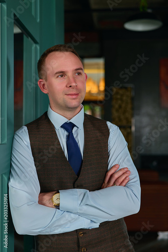 a man in a business suit in a stylish interior