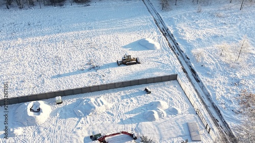 Bild auf Leinwand Drone image of winter machinery and snow tracks
