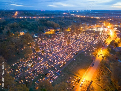 Obraz na plátně Evening sky over candlelit cemetery grounds