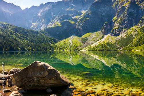 landscape with lake in mountains. scenic nature of poland with rocky summit reflection on the lake surface in summer. view of wonderful place in high tatra mountains for travel in eastern europe